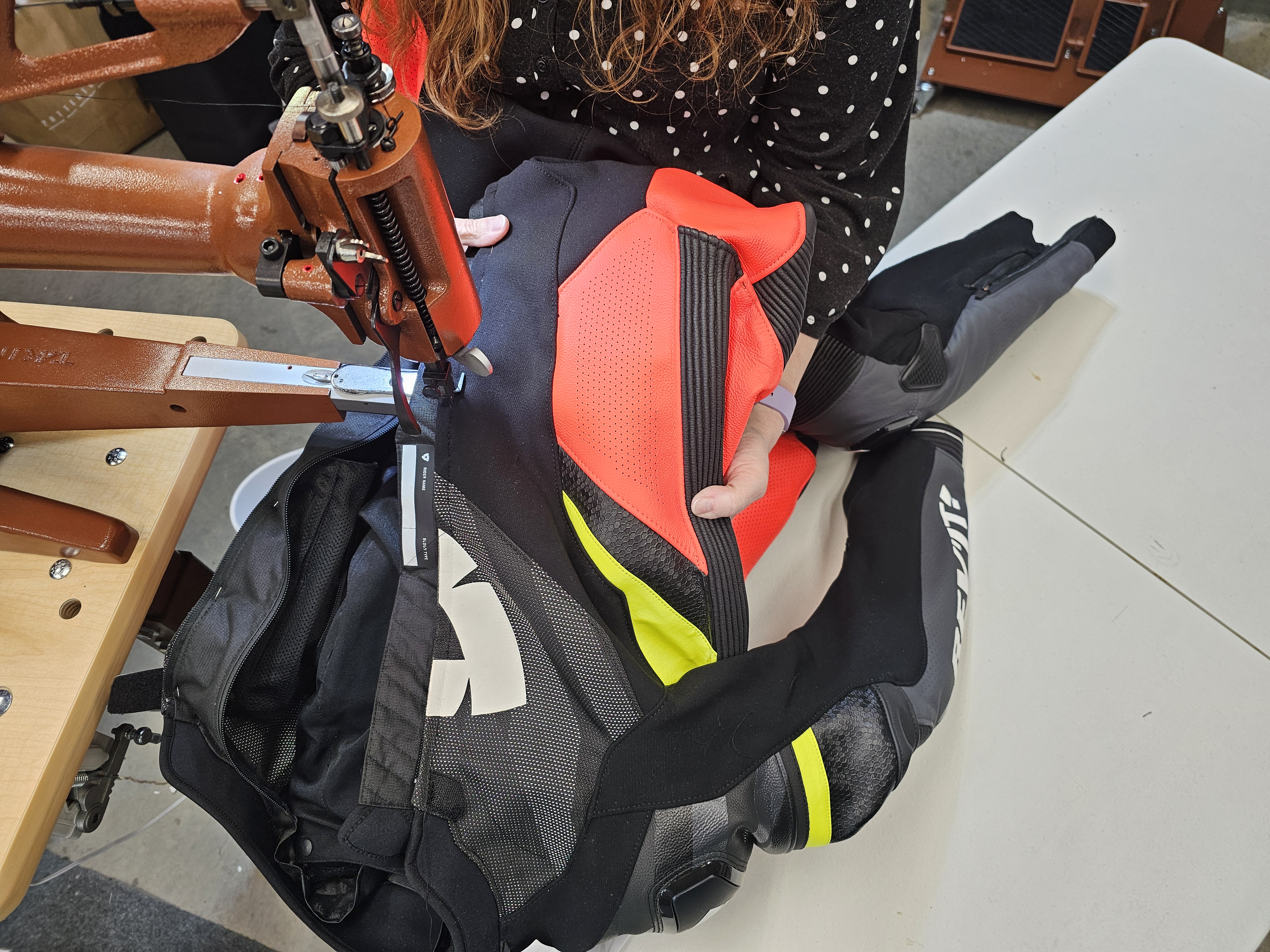 Nicole repairing a motorcycle outfit